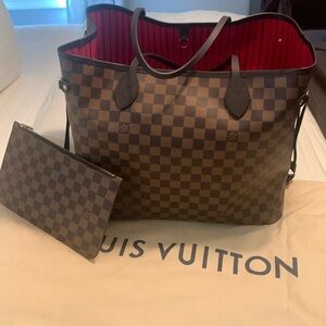 Authentic Louis Vuitton GM with wristlet Never full great condition